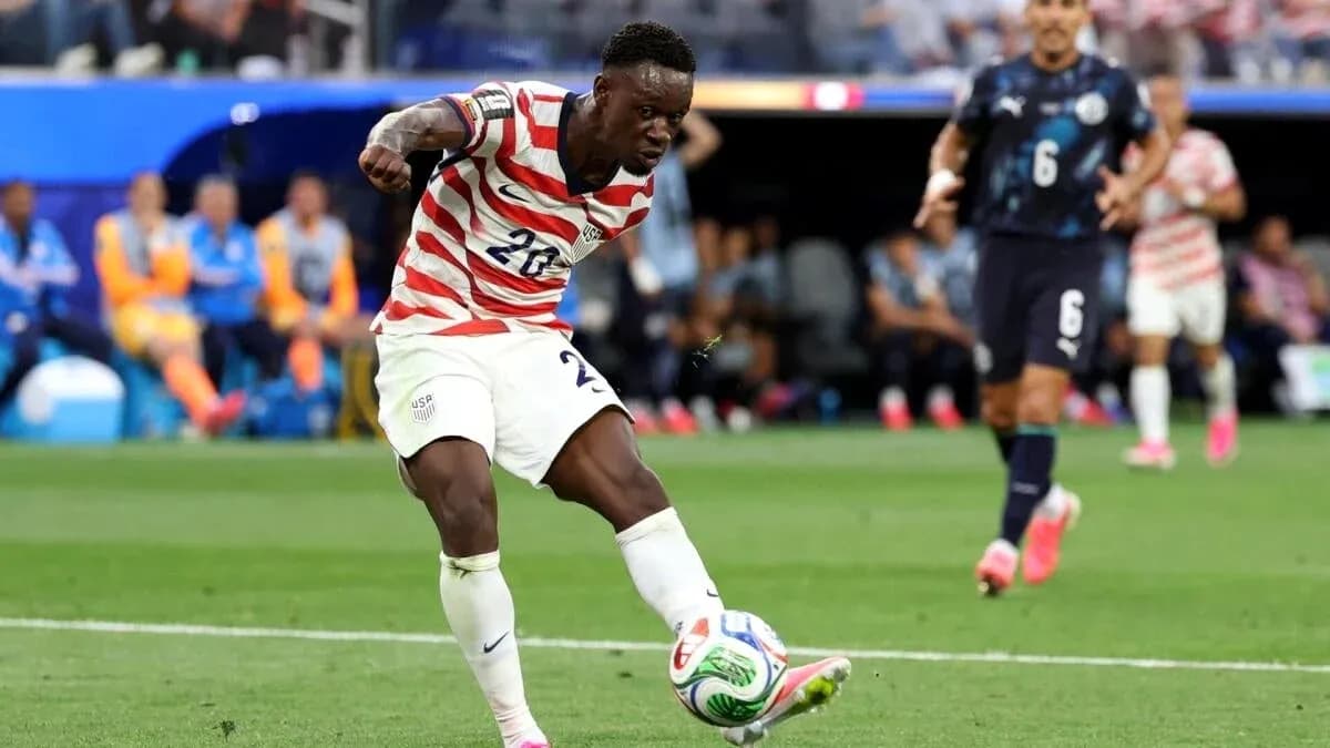 Jugador de Estados Unidos chutando el balón en partido