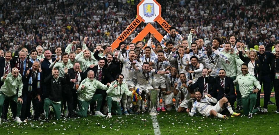 Equipo celebrando la victoria con trofeo en el campo