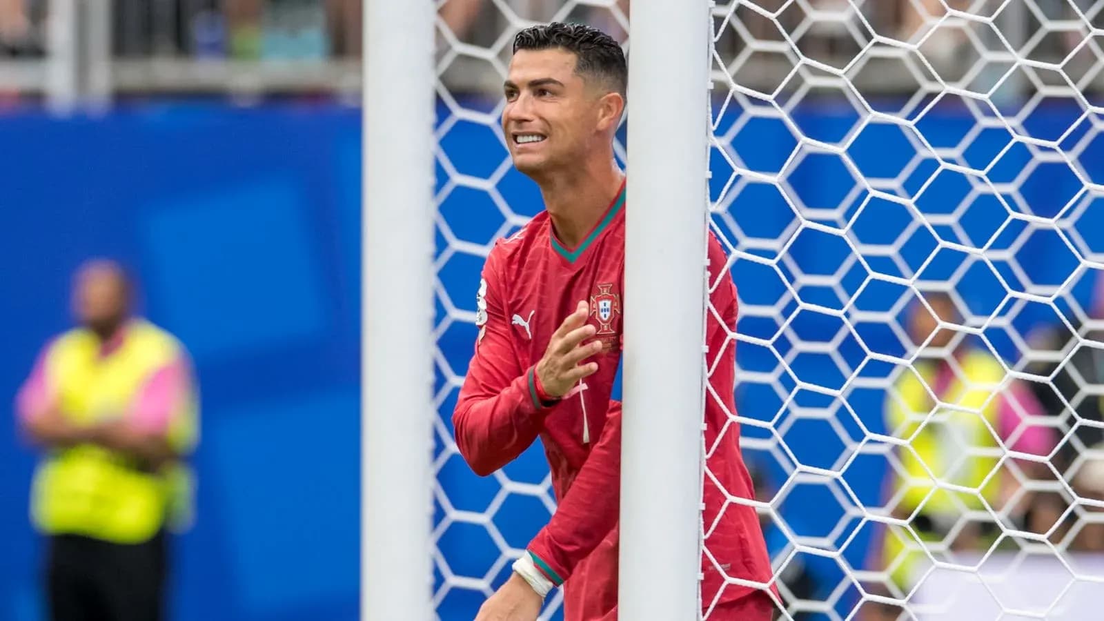 Cristiano Ronaldo celebrating behind the goal net