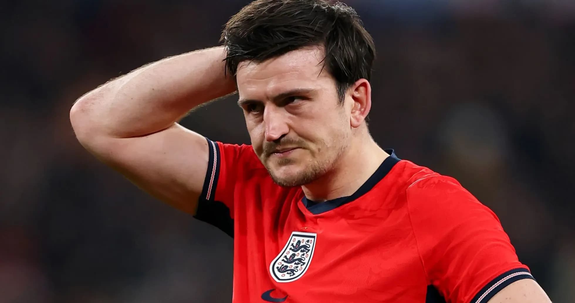 Jugador de Inglaterra con camiseta roja, gesto pensativo