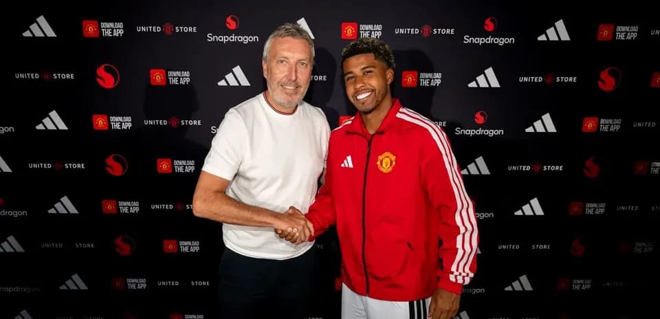 Jugadores de Manchester United posando y dándose la mano