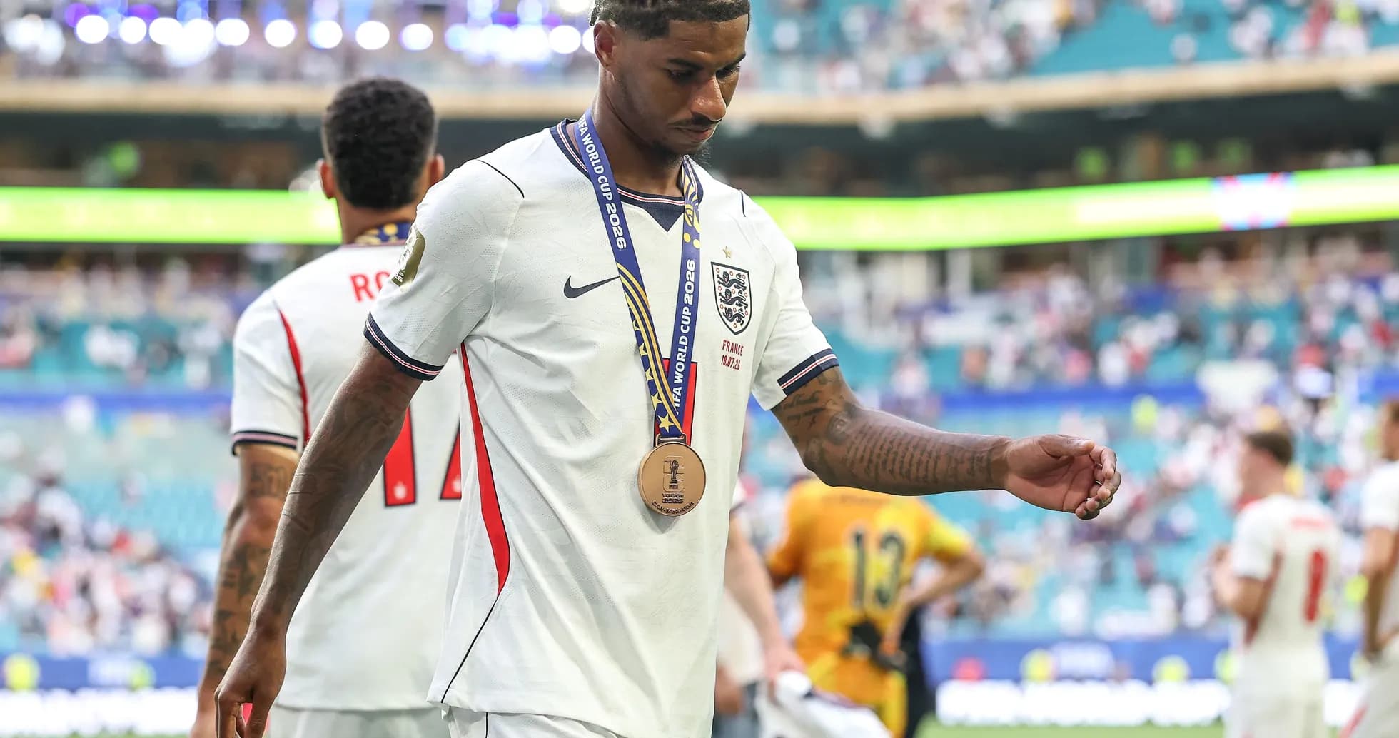 Jugador saliendo del campo con medalla de bronce