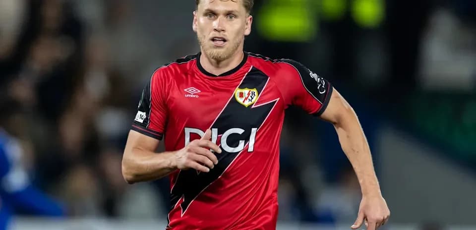 Jugador corriendo en uniforme de Rayo Vallecano