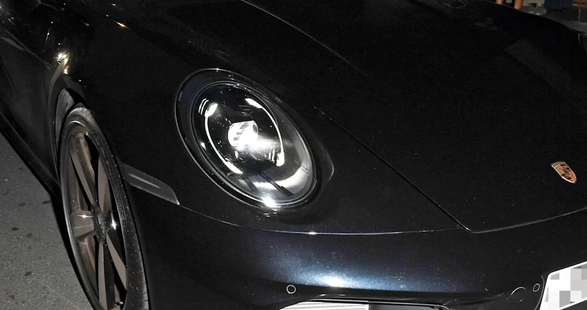Dos personas en un Porsche negro estacionado Dos personas en un Porsche negro estacionado
