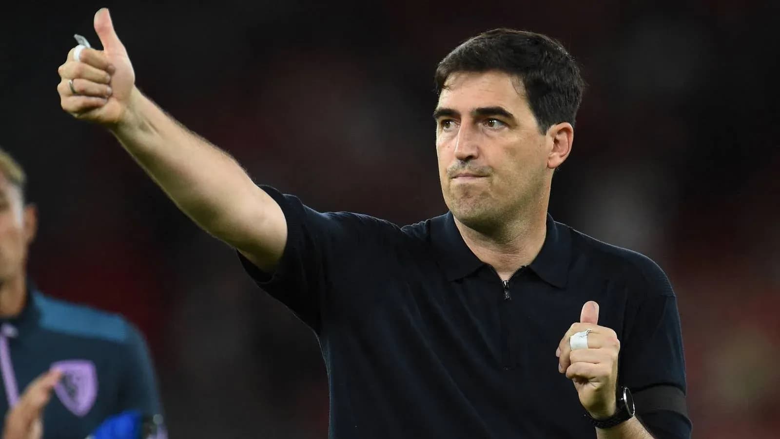 Entrenador señalando con pulgar hacia arriba en el campo Entrenador señalando con pulgar hacia arriba en el campo
