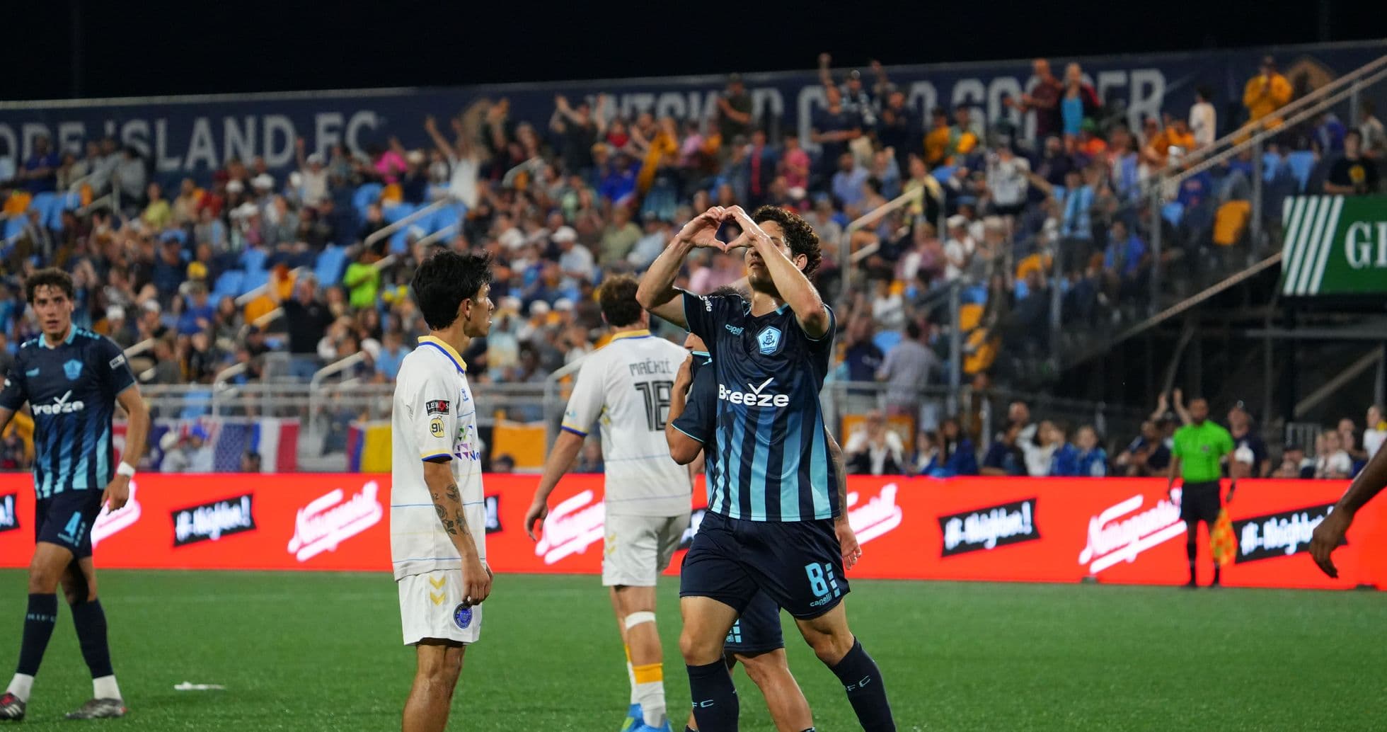Jugador celebra con un corazón durante el partido Jugador celebra con un corazón durante el partido